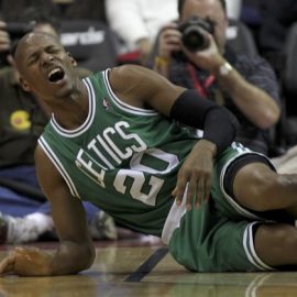 Boston Celtics' Ray Allen grimaces on the court in the first half of the NBA basketball game against the Washington Wizards