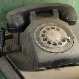 790018-old-dusty-rotary-dial-telephone-resting-on-a-table