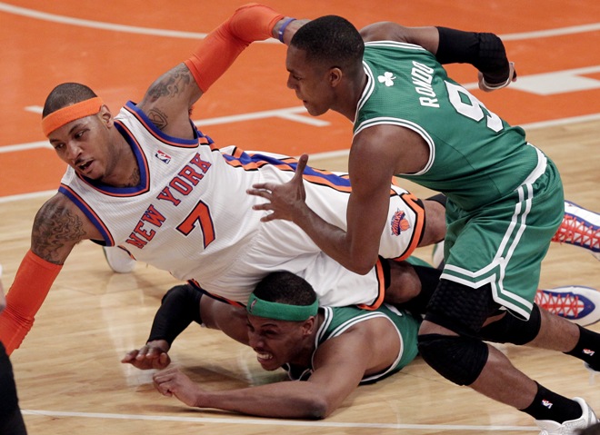 Boston Celtics Rajon Rondo watches New York Knicks Carmelo Anthony fall on Paul Pierce in the first half in the Eastern Conference first round of the NBA Playoffs at Madison Square Garden in New York City on April 22, 2011. The Celtics defeated the Knicks 113-96 and lead the series 3-0. UPI/John Angelillo