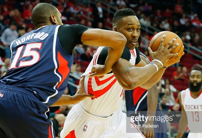 Dwight Howard #12 of the Houston Rockets battles for the basketball with Al Horford #15 of the Atlanta Hawks during their game at the Toyota Center on December 20, 2014 in Houston, Texas. *** Local Caption *** Dwight Howard; Al Horford