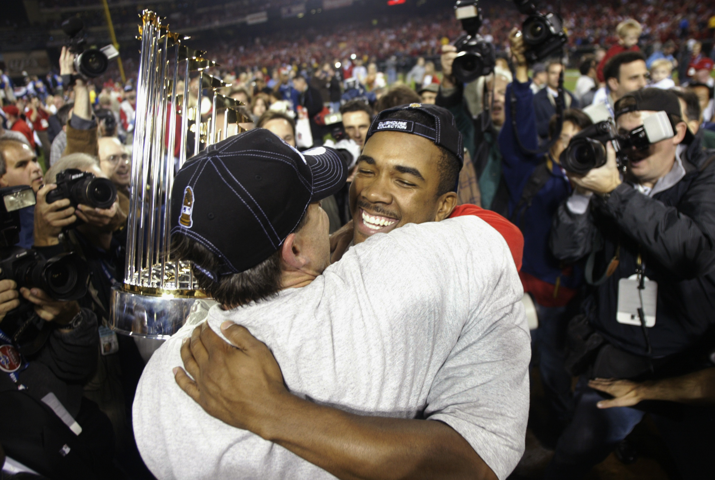 Tim Salmon hugs Garret Anderson after winning the World Series