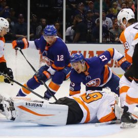 UNIONDALE, NY - SEPTEMBER 17: Mathew Barzal #13 and Josh Bailey #12 of the New York Islanders are stopped by Alex Lyon #49 of the Philadelphia Flyers during the first period during a preseason game at the Nassau Veterans Memorial Coliseum on September 17, 2017 in Uniondale, New York. (Photo by Bruce Bennett/Getty Images)