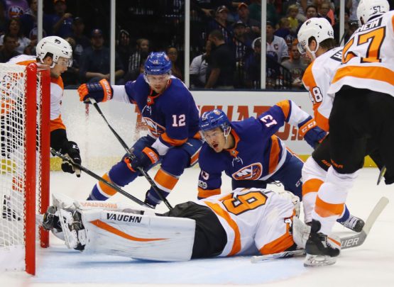 UNIONDALE, NY - SEPTEMBER 17: Mathew Barzal #13 and Josh Bailey #12 of the New York Islanders are stopped by Alex Lyon #49 of the Philadelphia Flyers during the first period during a preseason game at the Nassau Veterans Memorial Coliseum on September 17, 2017 in Uniondale, New York. (Photo by Bruce Bennett/Getty Images)