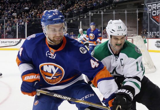 NEW YORK, NY - JANUARY 03: Calvin de Haan #44 of the New York Islanders fends off Jamie Benn #14 of the Dallas Stars skates against the New York Islanders at the Barclays Center on January 3, 2016 in the Brooklyn borough of New York City. The Islanders defeated the Stars 6-5. (Photo by Bruce Bennett/Getty Images)