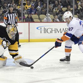 Dec 7, 2017; Pittsburgh, PA, USA;Pittsburgh Penguins goalie Tristan Jarry (35) makes a save against New York Islanders left wing Anders Lee (27) during the first period of an NHL hockey game at PPG PAINTS Arena. Mandatory Credit: Don Wright-USA TODAY Sports