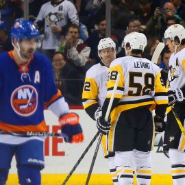 Jan 5, 2018; Brooklyn, NY, USA; Pittsburgh Penguins center Evgeni Malkin (71) is congratulated after scoring a goal as New York Islanders right wing Cal Clutterbuck (15) skates away during the second period at Barclays Center. Mandatory Credit: Andy Marlin-USA TODAY Sports