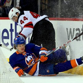 Jan 16, 2018; Brooklyn, NY, USA; New Jersey Devils left wing Miles Wood (44) and New York Islanders defenseman Sebastian Aho (28) collide at the boards during the first period at Barclays Center. Mandatory Credit: Andy Marlin-USA TODAY Sports