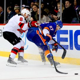 Jan 16, 2018; Brooklyn, NY, USA; New Jersey Devils defenseman Andy Greene (6) and New York Islanders left wing Anders Lee (27) battle for a loose puck during the second period at Barclays Center. Mandatory Credit: Andy Marlin-USA TODAY Sports