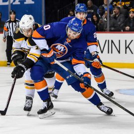 Jan 18, 2018; Brooklyn, NY, USA; New York Islanders defenseman Adam Pelech (50) and Boston Bruins left wing Jake DeBrusk (74) battle for the puck during the first period at the Barclays Center. Mandatory Credit: Dennis Schneidler-USA TODAY Sports