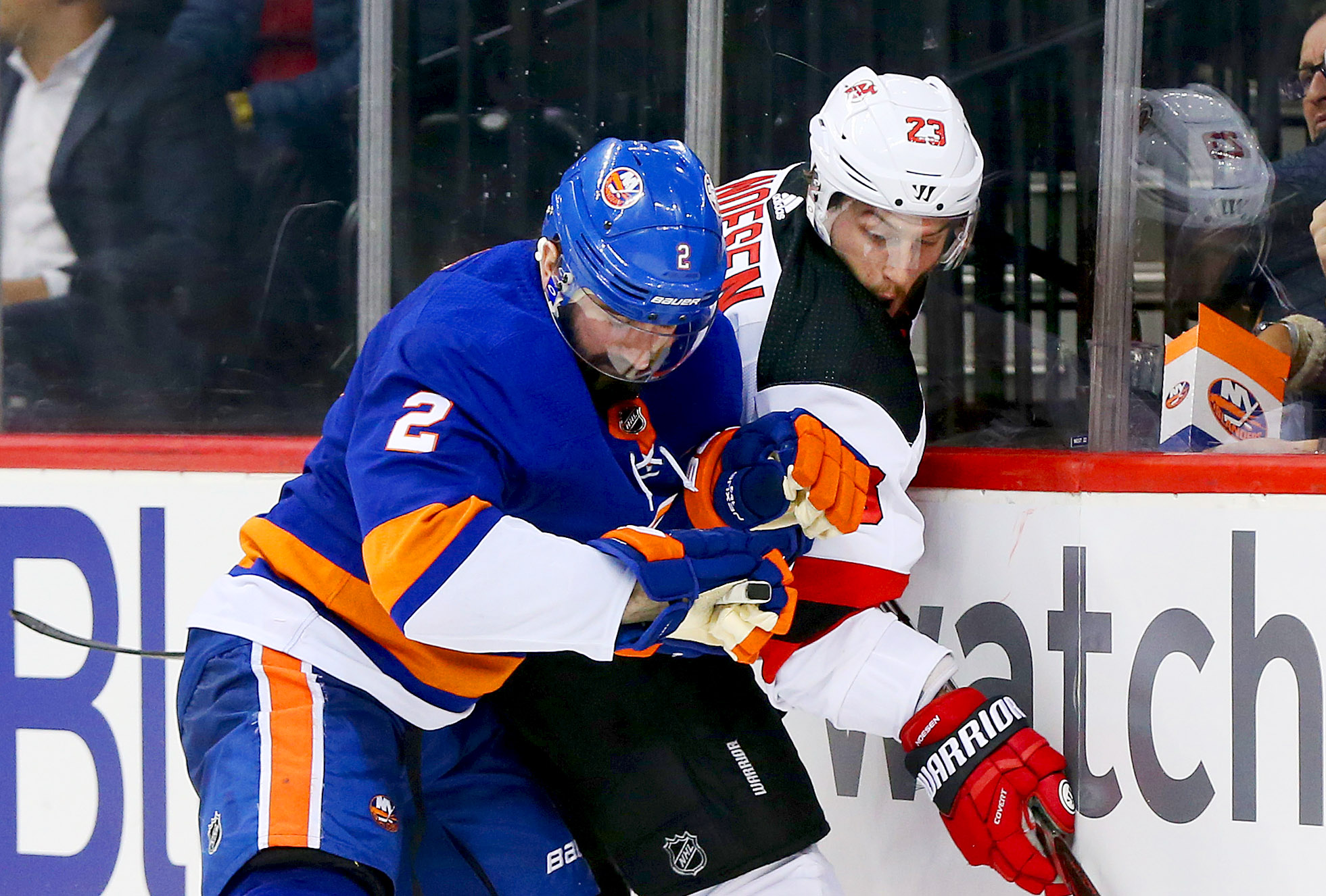 Jan 16, 2018; Brooklyn, NY, USA; New Jersey Devils right wing Stefan Noesen (23) and New York Islanders defenseman Nick Leddy (2) battle for position along the boards during the third period at Barclays Center. Mandatory Credit: Andy Marlin-USA TODAY Sports