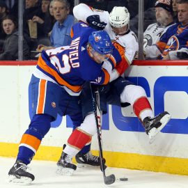 Jan 30, 2018; Brooklyn, NY, USA; New York Islanders defenseman Scott Mayfield (42) hits Florida Panthers center Jonathan Huberdeau (11) as they fight for the puck during the first period at Barclays Center. Mandatory Credit: Brad Penner-USA TODAY Sports