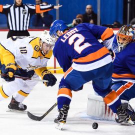 Feb 5, 2018; Brooklyn, NY, USA; New York Islanders goaltender Jaroslav Halak (41) makes a save and Nashville Predators center Colton Sissons (10) and New York Islanders defenseman Nick Leddy (2) fight over the loose puck during the first period at Barclays Center. Mandatory Credit: Dennis Schneidler-USA TODAY Sports