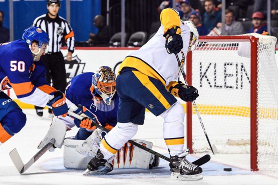Feb 5, 2018; Brooklyn, NY, USA; Nashville Predators left wing Kevin Fiala (22) puts in a rebound against the New York Islanders during the first period at Barclays Center. Mandatory Credit: Dennis Schneidler-USA TODAY Sports