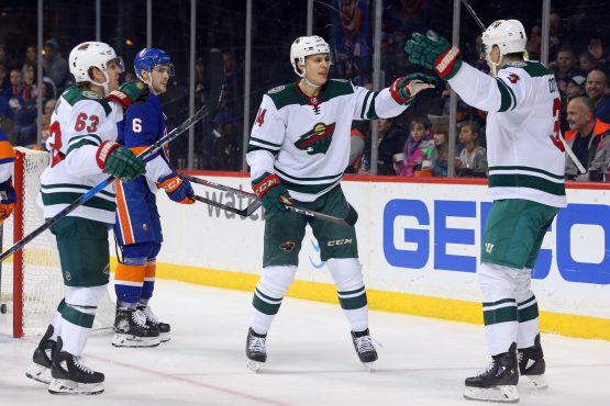 Feb 19, 2018; Brooklyn, NY, USA; Minnesota Wild center Joel Eriksson Ek (14) celebrates his goal against the New York Islanders with center Charlie Coyle (3) and left wing Tyler Ennis (63) during the first period at Barclays Center. Mandatory Credit: Brad Penner-USA TODAY Sports