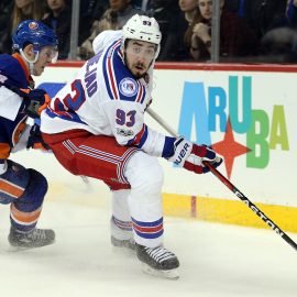 Feb 16, 2017; Brooklyn, NY, USA; New York Rangers center Mika Zibanejad (93) plays the puck against New York Islanders defenseman Thomas Hickey (14) during the third period at Barclays Center. Mandatory Credit: Brad Penner-USA TODAY Sports