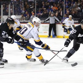 Mar 27, 2017; Brooklyn, NY, USA; Nashville Predators center Colton Sissons (10) plays the puck against New York Islanders center Anders Lee (27) and New York Islanders defenseman Adam Pelech (50) during the third period at Barclays Center. Mandatory Credit: Brad Penner-USA TODAY Sports
