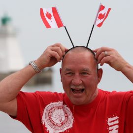 Happy Canadian with flags