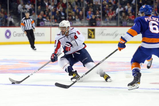 Dec 11, 2017; Brooklyn, NY, USA; Washington Capitals left wing Alex Ovechkin (8) plays the puck against New York Islanders defenseman Ryan Pulock (6) during the third period at Barclays Center. Mandatory Credit: Brad Penner-USA TODAY Sports