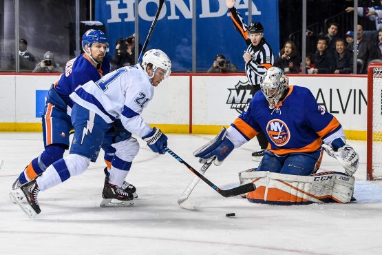 Mar 22, 2018; Brooklyn, NY, USA; Tampa Bay Lightning center Brayden Point (21) shoots against New York Islanders goaltender Christopher Gibson (33) during the first period at Barclays Center. Mandatory Credit: Dennis Schneidler-USA TODAY Sports