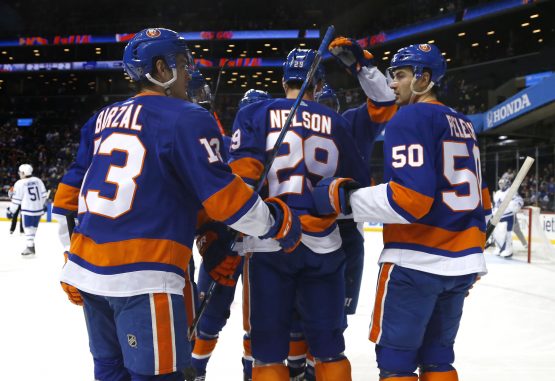 Mar 30, 2018; Brooklyn, NY, USA; New York Islanders center Brock Nelson (29) celebrates with center Mathew Barzal (13) and defenseman Adam Pelech (50) after scoring a goal against Toronto Maple Leafs during the second period at Barclays Center. Mandatory Credit: Noah K. Murray-USA TODAY Sports