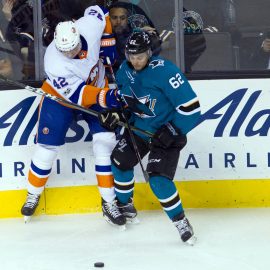 Oct 14, 2017; San Jose, CA, USA; New York Islanders defender Scott Mayfield (42) and San Jose Sharks right wing Kevin Labanc (62) fight for the puck in the second period at SAP Center at San Jose. Mandatory Credit: Andrew Villa-USA TODAY Sports