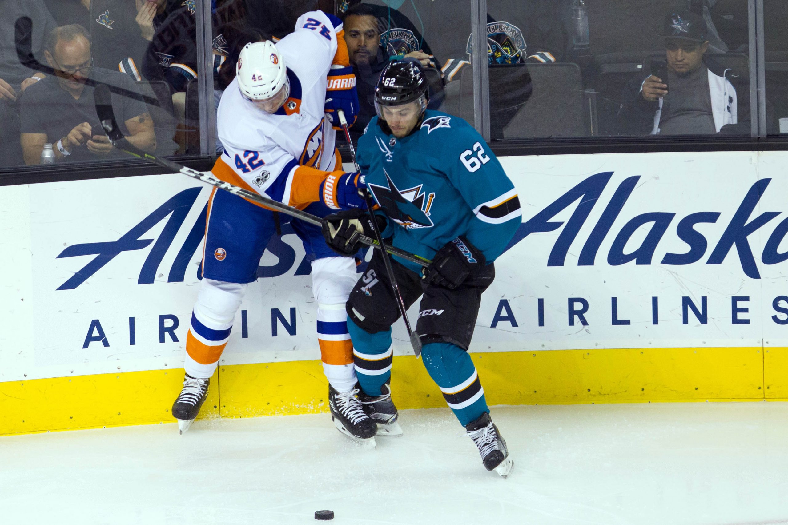 Oct 14, 2017; San Jose, CA, USA; New York Islanders defender Scott Mayfield (42) and San Jose Sharks right wing Kevin Labanc (62) fight for the puck in the second period at SAP Center at San Jose. Mandatory Credit: Andrew Villa-USA TODAY Sports