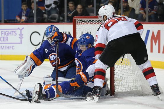 Nov 3, 2018; Brooklyn, NY, USA; New York Islanders goaltender Thomas Greiss (1) makes a save against New Jersey Devils left wing Marcus Johansson (90) in front of Islanders defenseman Thomas Hickey (4) during the third period at Barclays Center. Mandatory Credit: Brad Penner-USA TODAY Sports