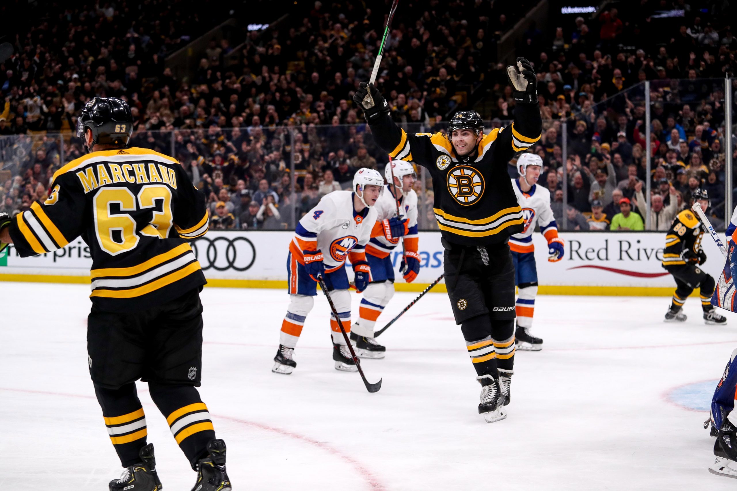 Nov 29, 2018; Boston, MA, USA; Boston Bruins left wing Jake DeBrusk (74) celebrates after a goal by Boston left wing Brad Marchand (63) against the New York Islanders during the second period at TD Garden. Mandatory Credit: Paul Rutherford-USA TODAY Sports