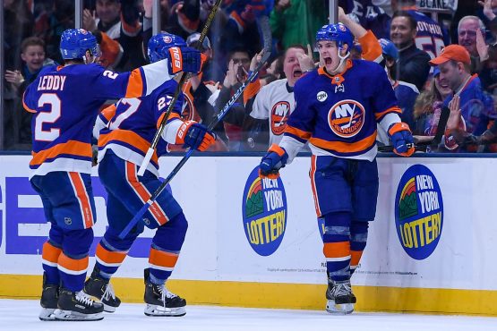 Dec 15, 2018; Uniondale, NY, USA; New York Islanders center Mathew Barzal (13) celebrates with New York Islanders defenseman Nick Leddy (2) and New York Islanders left wing Anders Lee (27) after scoring a goal against the Detroit Red Wings during the third period at Nassau Veterans Memorial Coliseum. Mandatory Credit: Dennis Schneidler-USA TODAY Sports