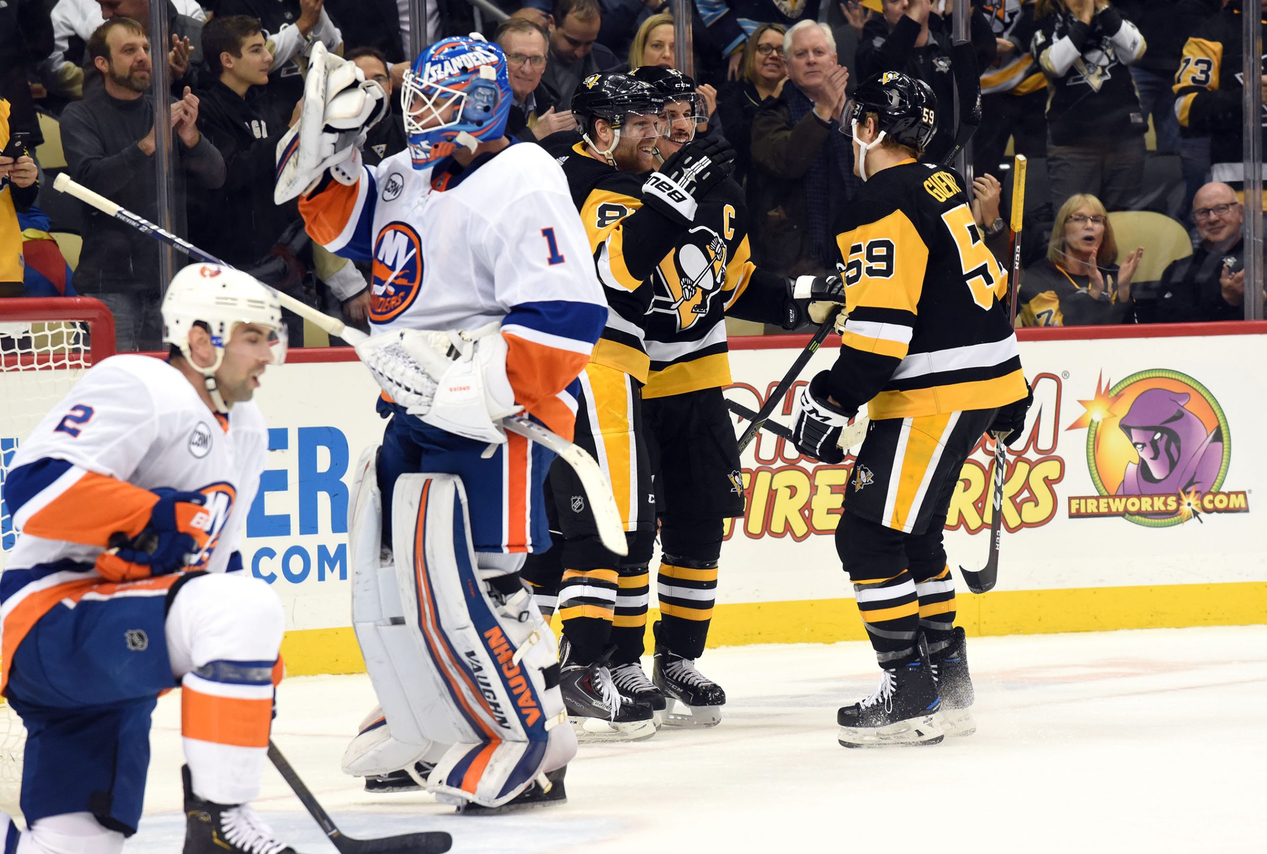 Dec 6, 2018; Pittsburgh, PA, USA; Pittsburgh Penguins winger Phil Kessel (81) celebrates a second period goal with captain Sidney Crosby (87) and winger Jake Guentzel (59) against the New York Islanders at PPG PAINTS Arena. Mandatory Credit: Philip G. Pavely-USA TODAY Sports