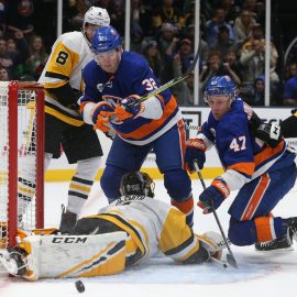 Dec 10, 2018; Uniondale, NY, USA; Pittsburgh Penguins goalie Casey DeSmith (1) makes a save against New York Islanders center Leo Komarov (47) in front of New York Islanders left wing Ross Johnston (32) during the second period at Nassau Veterans Memorial Coliseum. Mandatory Credit: Brad Penner-USA TODAY Sports