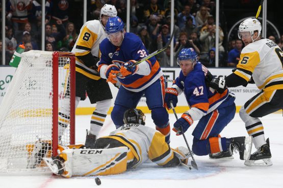 Dec 10, 2018; Uniondale, NY, USA; Pittsburgh Penguins goalie Casey DeSmith (1) makes a save against New York Islanders center Leo Komarov (47) in front of New York Islanders left wing Ross Johnston (32) during the second period at Nassau Veterans Memorial Coliseum. Mandatory Credit: Brad Penner-USA TODAY Sports