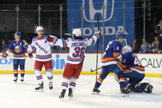 Jan 12, 2019; Brooklyn, NY, USA; New York Rangers right wing Mats Zuccarello (36) celebrates his game winning goal against New York Islanders goalie Robin Lehner (40) with Rangers left wing Chris Kreider (20) during the third period at Barclays Center. Mandatory Credit: Brad Penner-USA TODAY Sports