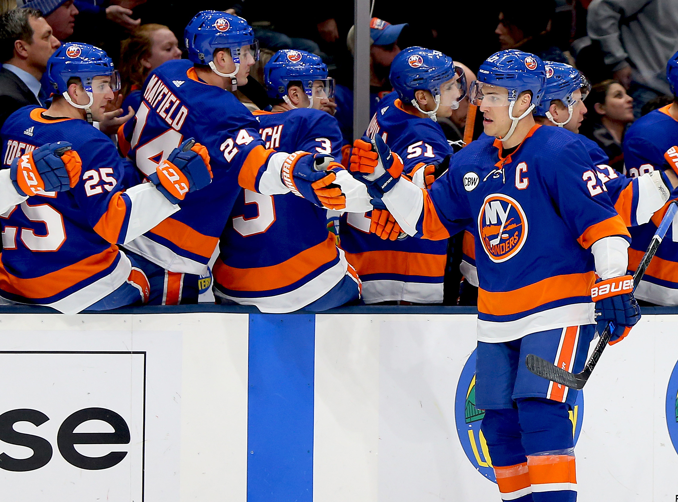 Jan 17, 2019; Uniondale, NY, USA; New York Islanders left wing Anders Lee (27) celebrates with teammates on the bench after scoring a goal against the New Jersey Devils during the first period at Nassau Veterans Memorial Coliseum. Mandatory Credit: Andy Marlin-USA TODAY Sports