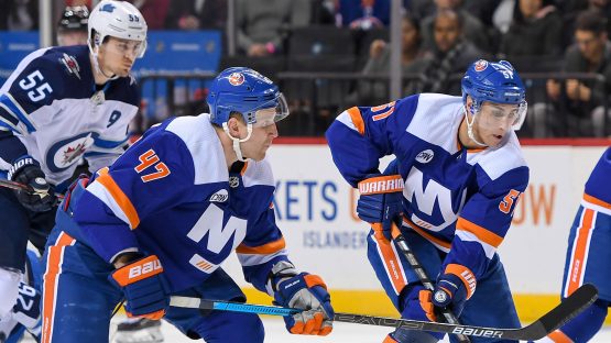 Dec 4, 2018; Brooklyn, NY, USA; New York Islanders center Valtteri Filppula (51) skates the puck across the blue line with New York Islanders right wing Tom Kuhnhackl (14) and New York Islanders right wing Leo Komarov (47) against the Winnipeg Jets during the second period at Barclays Center. Mandatory Credit: Dennis Schneidler-USA TODAY Sports
