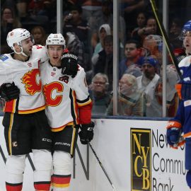 Feb 26, 2019; Uniondale, NY, USA; Calgary Flames center Mikael Backlund (11) celebrates with Calgary Flames defenseman Mark Giordano (5) in front of New York Islanders right wing Cal Clutterbuck (15) after scoring a goal during the third period at Nassau Veterans Memorial Coliseum. Mandatory Credit: Brad Penner-USA TODAY Sports