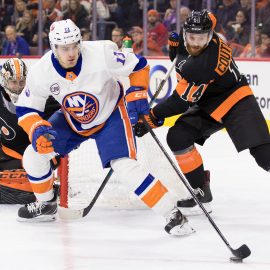 Mar 23, 2019; Philadelphia, PA, USA; New York Islanders center Mathew Barzal (13) skates with the puck in front of Philadelphia Flyers center Sean Couturier (14) and goaltender Carter Hart (79) during the second period at Wells Fargo Center. Mandatory Credit: Bill Streicher-USA TODAY Sports