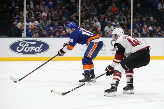 Mar 24, 2019; Uniondale, NY, USA; New York Islanders left wing Andrew Ladd (16) takes a backhanded shot in front of Arizona Coyotes right wing Michael Grabner (40) during the second period at Nassau Veterans Memorial Coliseum. Mandatory Credit: Brad Penner-USA TODAY Sports