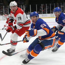 Jan 8, 2019; Uniondale, NY, USA; Carolina Hurricanes left wing Micheal Ferland (79) fights for the puck against New York Islanders center Casey Cizikas (53) and defenseman Scott Mayfield (24) during the third period at Nassau Veterans Memorial Coliseum. Mandatory Credit: Brad Penner-USA TODAY Sports