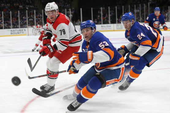 Jan 8, 2019; Uniondale, NY, USA; Carolina Hurricanes left wing Micheal Ferland (79) fights for the puck against New York Islanders center Casey Cizikas (53) and defenseman Scott Mayfield (24) during the third period at Nassau Veterans Memorial Coliseum. Mandatory Credit: Brad Penner-USA TODAY Sports