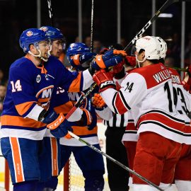 Apr 26, 2019; Brooklyn, NY, USA; New York Islanders right wing Tom Kuhnhackl (14) and Carolina Hurricanes right wing Justin Williams (14) scuffle during the first period in game one of the second round of the 2019 Stanley Cup Playoffs at Barclays Center. Mandatory Credit: Catalina Fragoso-USA TODAY Sports