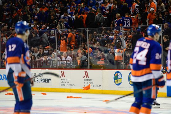 Apr 26, 2019; Brooklyn, NY, USA; Fans throw rally shirts onto the ice after the New York Islanders lose 0-1 to the Carolina Hurricanes in overtime in game one of the second round of the 2019 Stanley Cup Playoffs at Barclays Center. Mandatory Credit: Catalina Fragoso-USA TODAY Sports