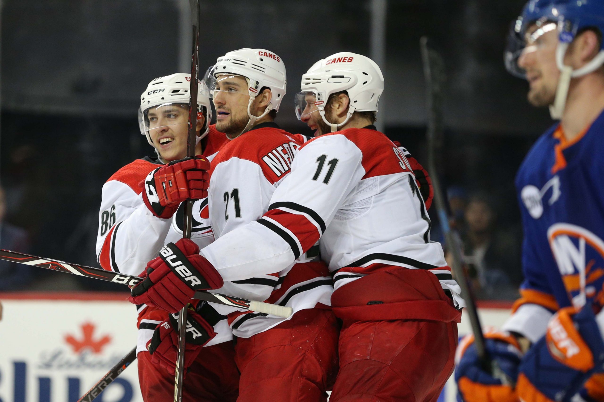 Apr 28, 2019; Brooklyn, NY, USA; Carolina Hurricanes right wing Nino Niederreiter (21) celebrates his goal against the New York Islanders with left wing Teuvo Teravainen (86) and center Jordan Staal (11) during the third period of game two of the second round of the 2019 Stanley Cup Playoffs at Barclays Center. Mandatory Credit: Brad Penner-USA TODAY Sports