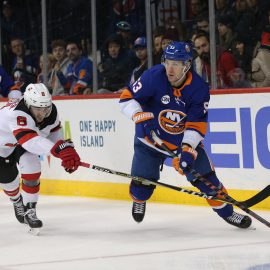 Nov 3, 2018; Brooklyn, NY, USA; New York Islanders center Casey Cizikas (53) plays the puck against New Jersey Devils defenseman Will Butcher (8) during the second period at Barclays Center. Mandatory Credit: Brad Penner-USA TODAY Sports