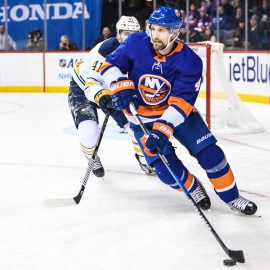 Dec 27, 2017; Brooklyn, NY, USA; New York Islanders defenseman Dennis Seidenberg (4) looks to make a pass defended by Buffalo Sabres defenseman Justin Falk (41) during the second period go the game between the New York Islanders and the Buffalo Sabres at Barclays Center. Mandatory Credit: Dennis Schneidler-USA TODAY Sports