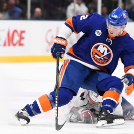 Mar 1, 2019; Uniondale, NY, USA; Washington Capitals defenseman Dmitry Orlov (9) and New York Islanders left wing Ross Johnston (32) battle for the puck during the third period at Nassau Veterans Memorial Coliseum. Mandatory Credit: Dennis Schneidler-USA TODAY Sports