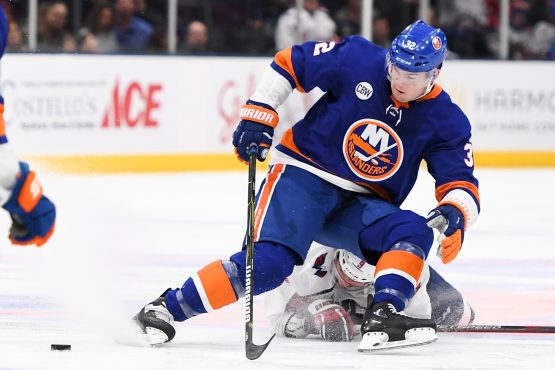 Mar 1, 2019; Uniondale, NY, USA; Washington Capitals defenseman Dmitry Orlov (9) and New York Islanders left wing Ross Johnston (32) battle for the puck during the third period at Nassau Veterans Memorial Coliseum. Mandatory Credit: Dennis Schneidler-USA TODAY Sports