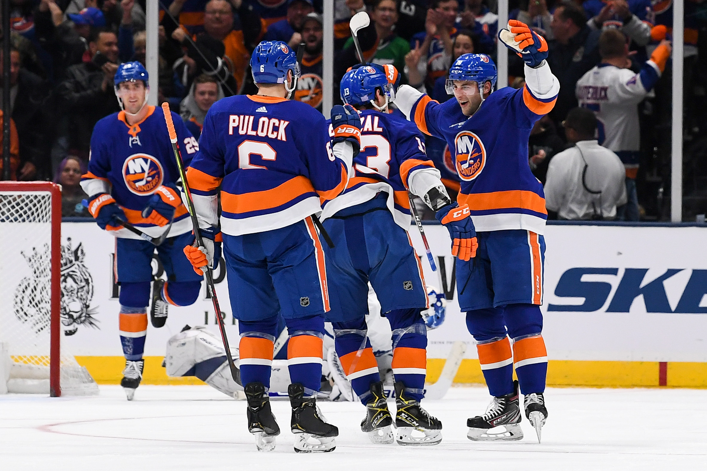 Nov 13, 2019; Uniondale, NY, USA; New York Islanders center Derick Brassard (10) celebrates with center Mathew Barzal (13) and defenseman Ryan Pulock (6) after scoring a goal against the Toronto Maple Leafs during the third period at Nassau Veterans Memorial Coliseum. Mandatory Credit: Dennis Schneidler-USA TODAY Sports