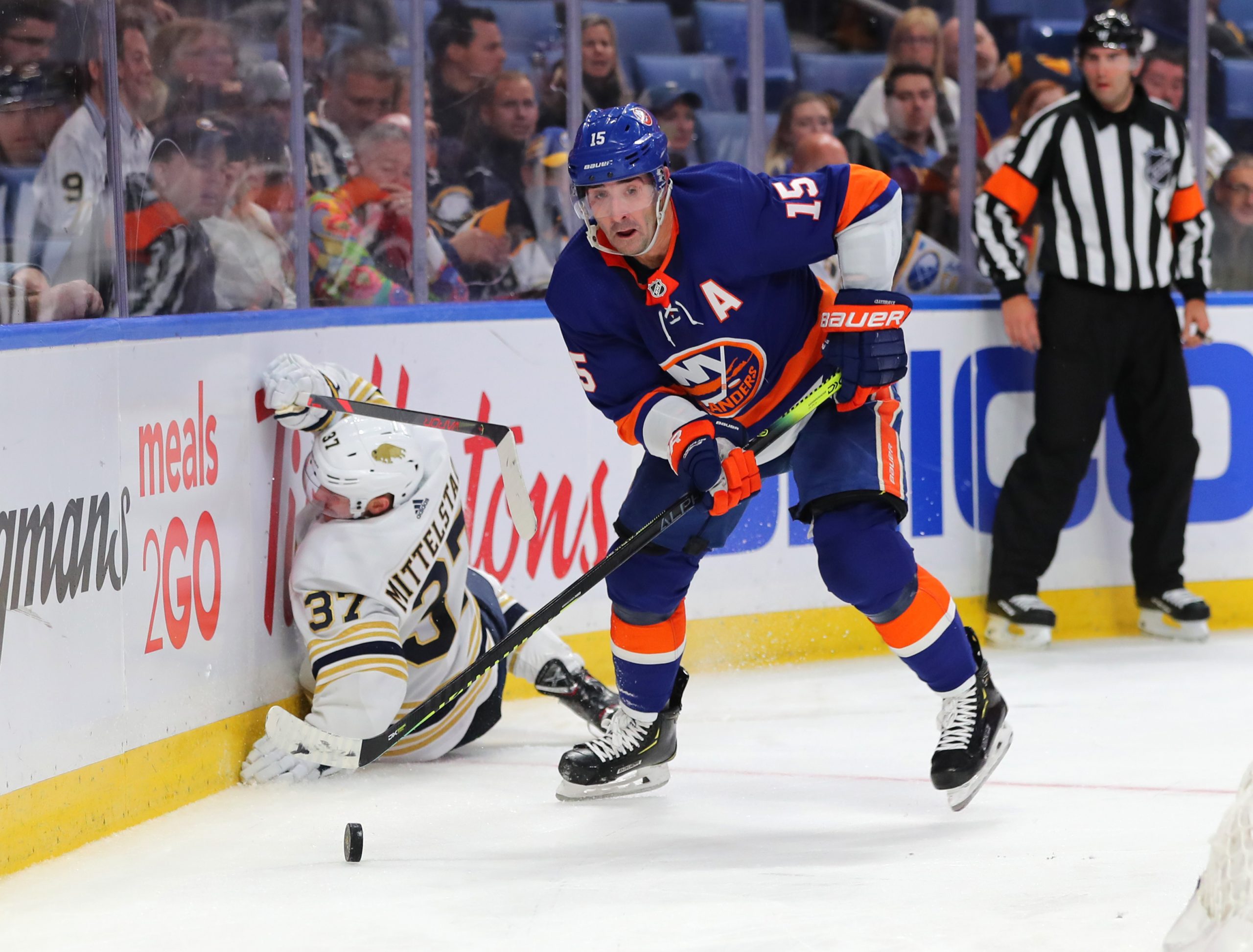 Nov 2, 2019; Buffalo, NY, USA; New York Islanders right wing Cal Clutterbuck (15) looks to make a pass as Buffalo Sabres center Casey Mittelstadt (37) falls down during the third period at KeyBank Center. Mandatory Credit: Timothy T. Ludwig-USA TODAY Sports