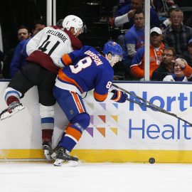 Jan 6, 2020; Brooklyn, New York, USA; New York Islanders defenseman Noah Dobson (8) and Colorado Avalanche center Pierre-Edouard Bellemare (41) battle for a loose puck during the first period at NYCB Live. Mandatory Credit: Andy Marlin-USA TODAY Sports